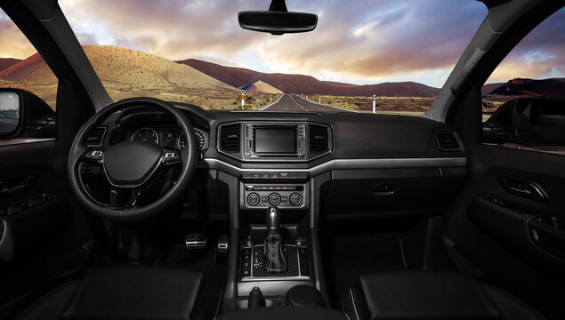 A black car with a large dashboard and a sunroof