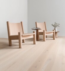 Two light oak wood chairs with thick legs and simple design sit on a light wood floor in a minimalist room, next to a small round side table and vase