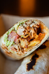 Breakfast falafel burrito wrap with fries, chicken and vegetables in a box. Tortilla wrap sandwich