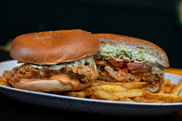 Close up of hamburger cut in a half with fries