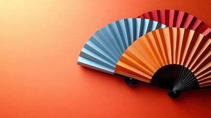 Colorful paper fans on a coral background