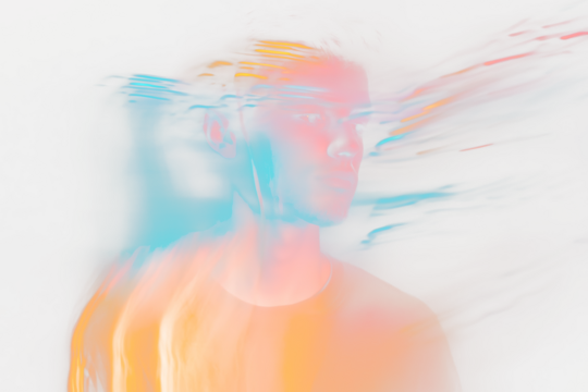 Young man portrait with colorful light trails.