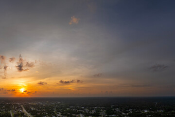 Fototapeta premium Evening sunset sky with colorful clouds over dark land. Panoramic skyscape