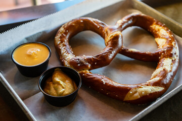 Large pretzel with sauces