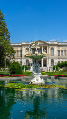 Fototapeta premium Fountain with swans in Dolmabahсe Palace in Istanbul, Turkey, on European coast of Bosporus strait in Turkiye. Vertical image