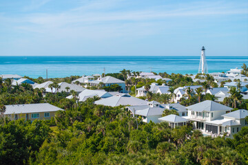 Premium housing development in the USA. Expensive waterfront houses between green palm trees in Boca Grande, small town on Gasparilla Island in southwest Florida
