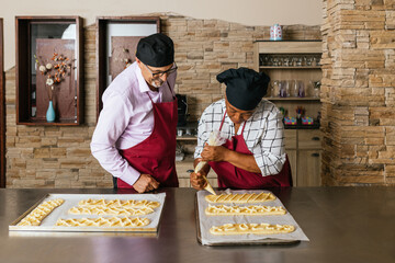 Bakers preparing pastries in kitchen during cooking course