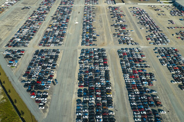 Used damaged cars on auction reseller company big parking lot ready for resale services. Sales of...