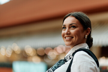 Latina businesswoman radiating confidence and style as she navigates the urban shopping center.