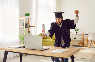Happy cheerful joyful excited elated ecstatic overjoyed man in student cap and gown celebrating...