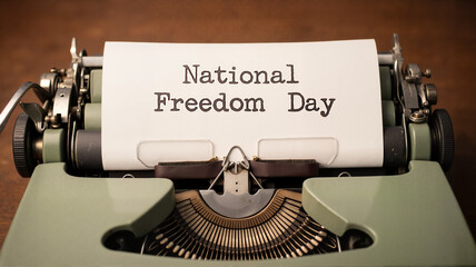 Typewriter with "National Freedom Day" text, for blogs, websites, and designs related to freedom, human rights, history, and social justice.