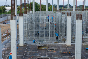 Steel roof structure, high scaffolding, preparing to pour concrete floor and cement pillars