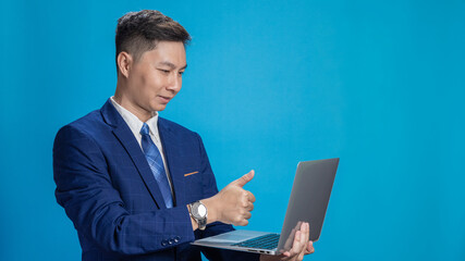 Confident young businessman in suit standing holding laptop in various poses