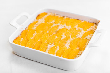 Pie with a sandy crumb with oranges in a forming form