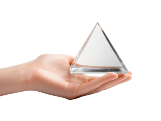 A hand holds a clear triangular prism, showcasing its geometric shape and clarity.