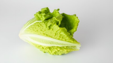 A fresh, vibrant romaine lettuce leaf showcasing its crisp texture and bright green color against a light background.  