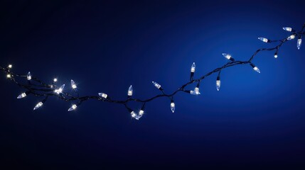 holiday illumination and decoration concept - christmas garland bokeh lights over dark blue background