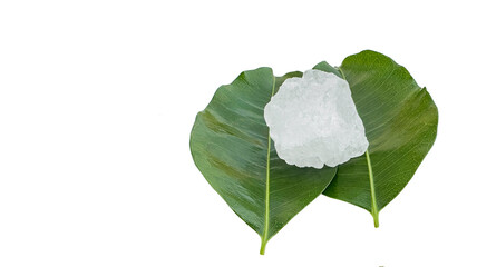 Crystal clear alum cubes or Potassium alum in on green leaves chemical compound substance concept for beauty spa and underarm treatment industrial