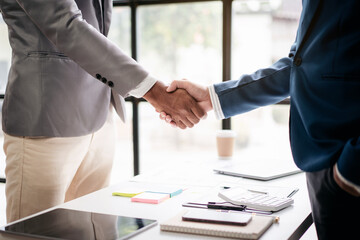 Two men shake hands in a business meeting