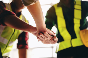 A group of construction workers are shaking hands