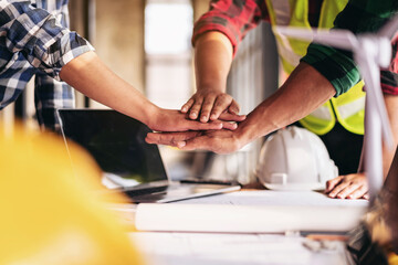 Three people are holding hands in a circle
