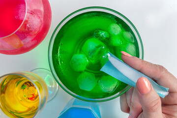 Pouring GHB into a colorful drink glass