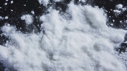 Powdered sugar falling on dark surface background for culinary design and baking concepts