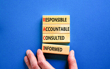 RACI symbol. Concept word RACI Responsible Accountable Consulted Informed on wooden blocks....