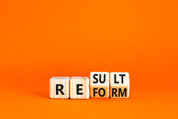 Reform and result symbol. Concept words Reform Result on beautiful wooden block. Beautiful orange...