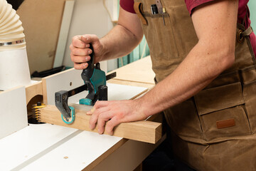 The carpenter is milling the oak parts for gluing