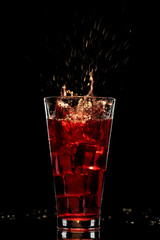 Red cocktail with ice, refreshing drink, alcoholic long drink