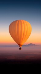 Fototapeta premium Scenic hot air balloon flight over majestic mountains at sunrise aerial tranquil atmosphere