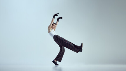 Full-length photo of young attractive man dressed fashion outfit, turning movement into art form...
