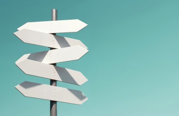 Five white blank street signs point different directions against teal sky. Signs mounted on metal pole, creating wayfinding concept. Copy space for destination message advertising banner design.