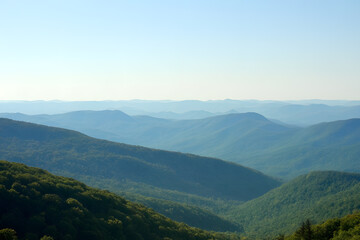 Fototapeta premium A breathtaking view of rolling mountains covered in lush greenery, with misty layers creating a serene and tranquil atmosphere, perfect for nature and travel enthusiasts.