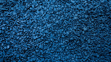 Dark blue gravel or rock pile background. Abstract night rough pattern. Rough style illustration. Cool feeling. Textured banner with space for text.