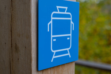 Blue Train Icon on Wooden Background