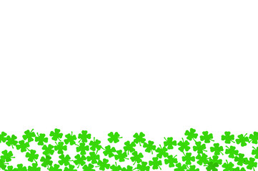 St Patricks Day background - borders of green quatrefoils on the white wooden surface, green...