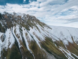 high relief mountains covered with snow, mountain range, aerial view drone shot