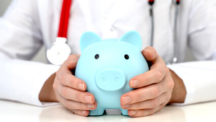 Doctor with stetascope and piggy bank