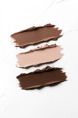 Fototapeta premium Mocha mousse, brown paint strokes on white background, texture, cosmetics