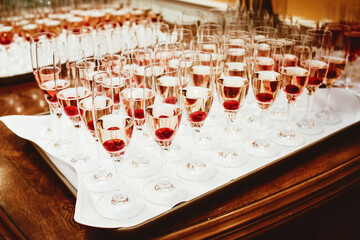 Tray with champagne glasses ready for celebration. Luxury banquet setting for birthdays, weddings, and special events. Sparkling wine served in a festive atmosphere. Cheers to joy and success!
