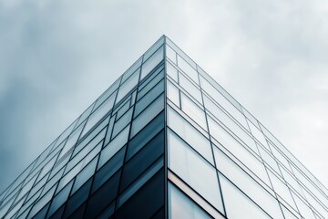 Intricate steel framework and reflective surfaces of a stunning high-rise building under a dramatic cloudy sky