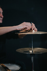 Musician adjusting hi-hat in preparation for a live performance