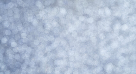 Abstract silver background with bokeh effect. Blurred circles of light create a sense of winter...