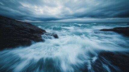 Dramatic Ocean Waves Crash Against Rocky Shoreline Under Clouds