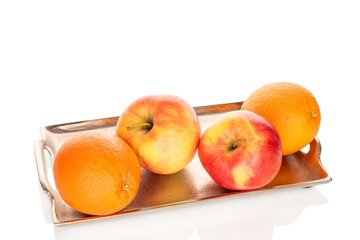 Two sweet oranges and two apples on a metal tray, close-up, isolated on a white background.