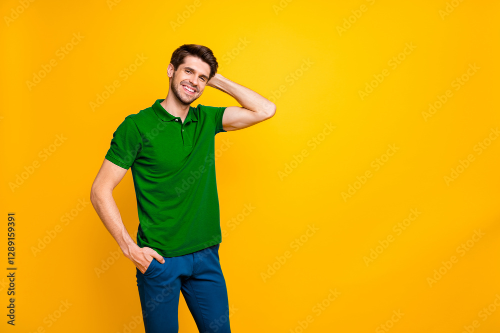 Poster photo of cheerful white handsome posing guy standing next to empty space with hand in pocket demonst