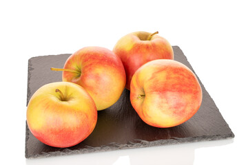 Several ripe apples on slate stone, close-up, isolated on white background.