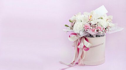 The bouquet is isolated on a pink background with space for text. Banner with flowers. A gift for a beloved woman. International Women's Day. Concept of love